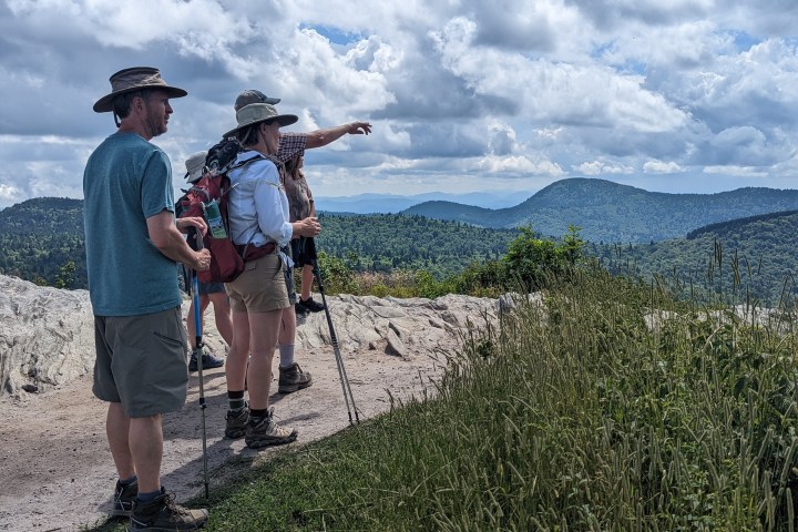 a group of people standing on top of a mountain